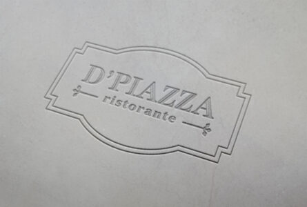 Embossed D'Piazza Ristorante logo on gray background.
