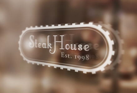 SteakHouse logo on glass window, established 1998.